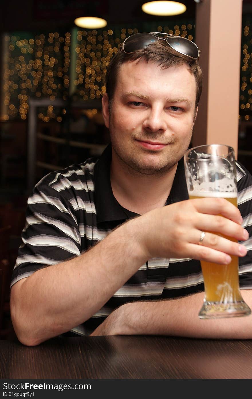 The man resting with beer in a bar. The man resting with beer in a bar