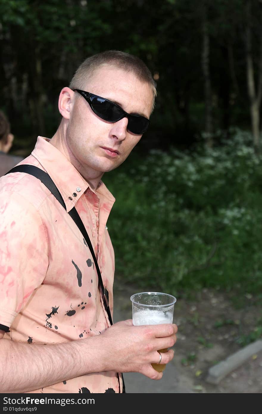 The man with glass of beer outdoor. The man with glass of beer outdoor