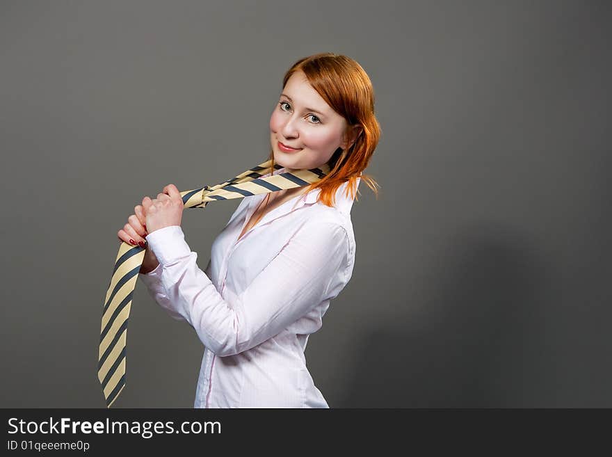 Red haired girl smiling with tie isolated. Red haired girl smiling with tie isolated