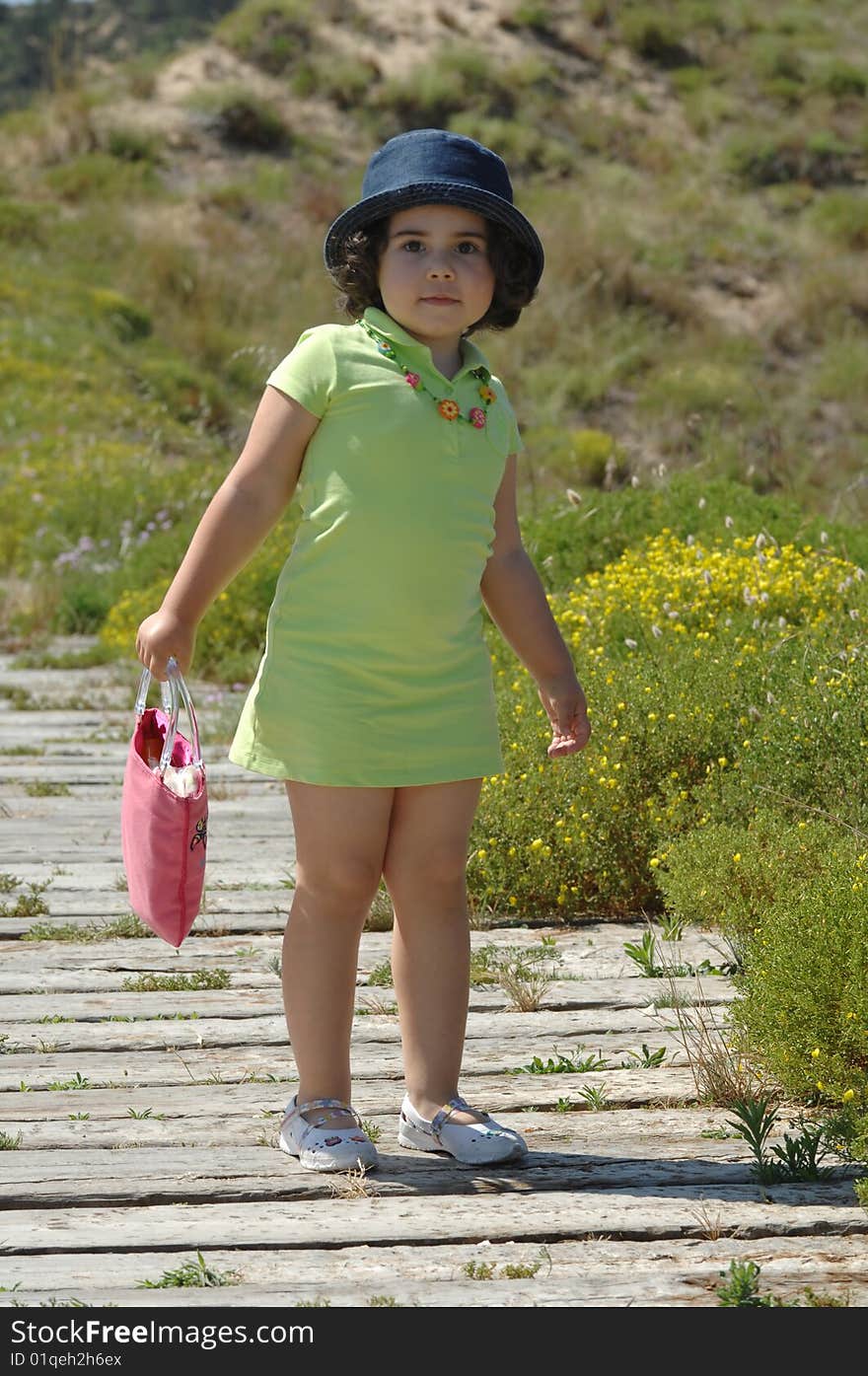 A little girl posing on a park