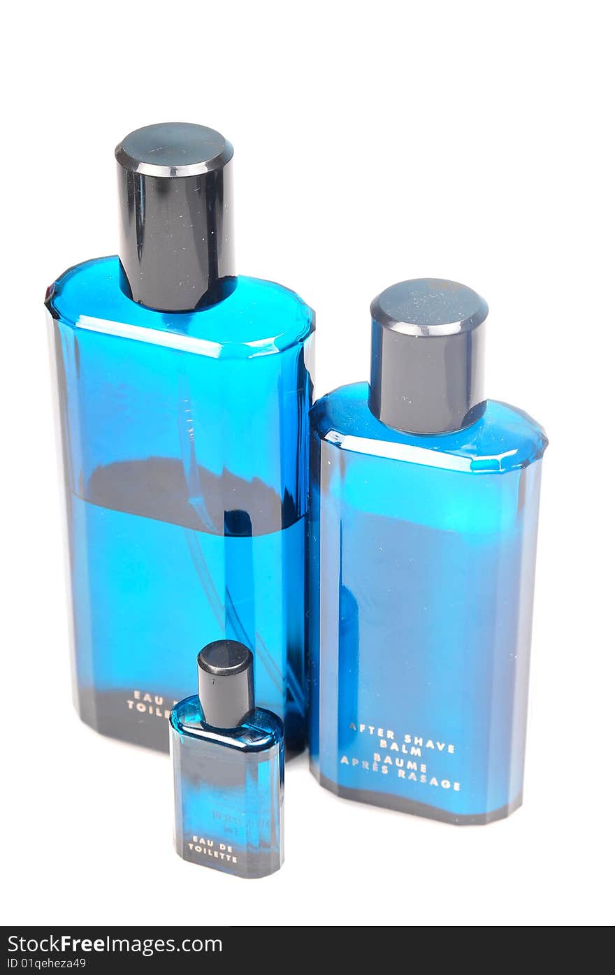 Blue bottles of perfume, after shave balm isolated on white background.