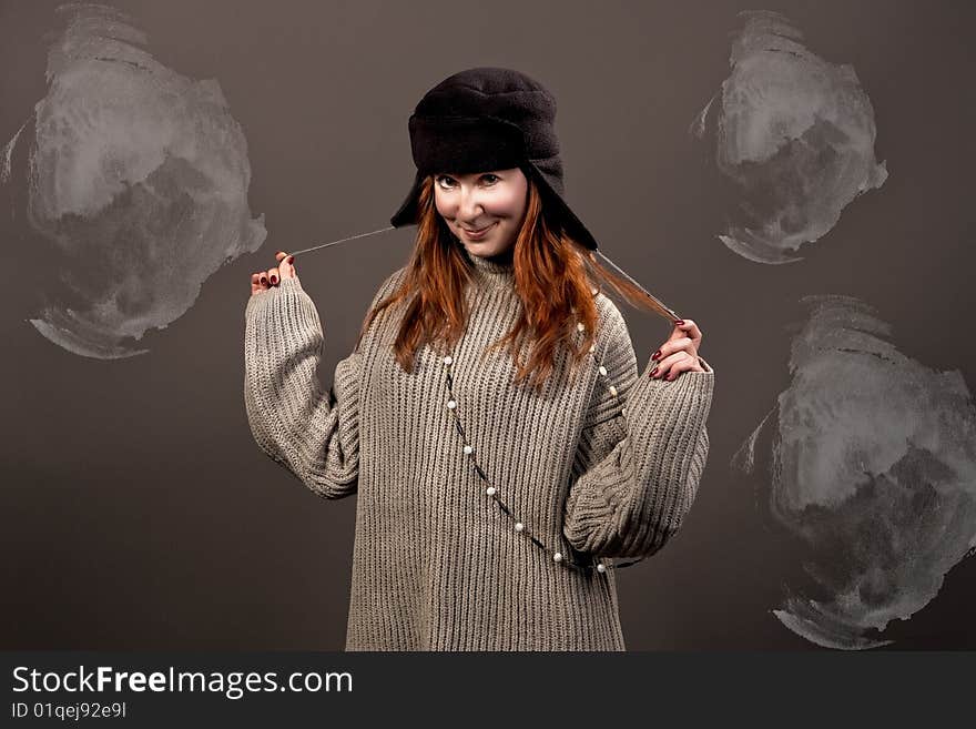 Young pretty woman in hat smiling separated over grey background