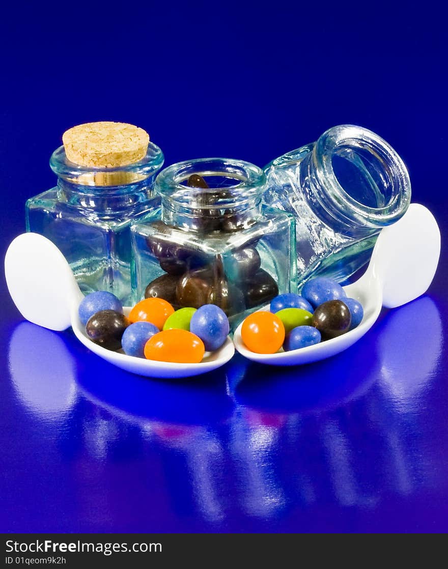 Crystal bottles and white spoons with chocolate