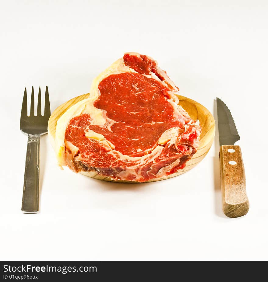 Meat on wood with knife and possesor