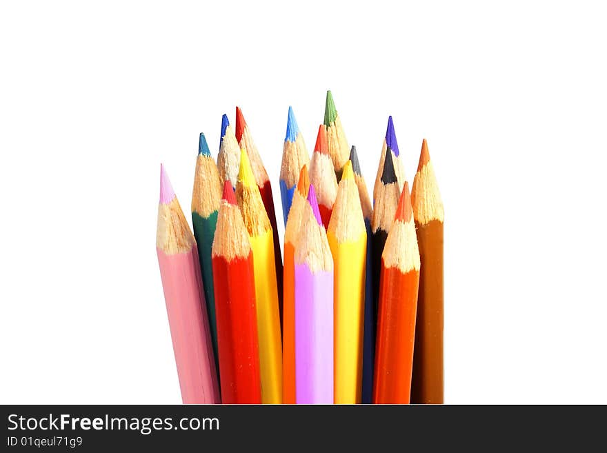 Set of colour pencils, for the drawing, spread out one after another, on the isolated white background