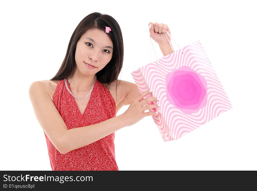 A beautiful Asian girl holds a shopping bag on white background. A beautiful Asian girl holds a shopping bag on white background.