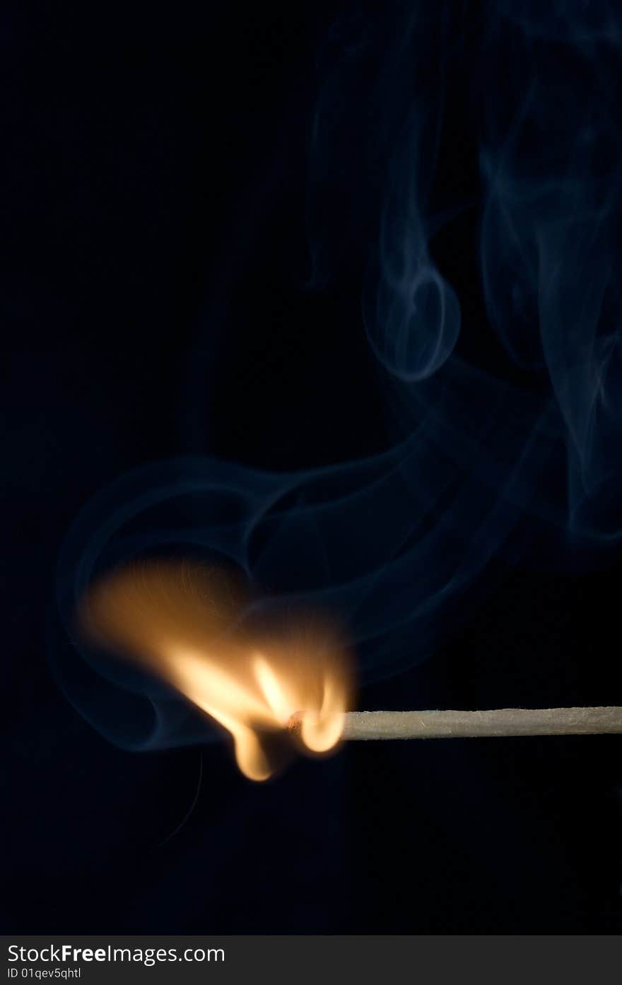 Burning Match on black background