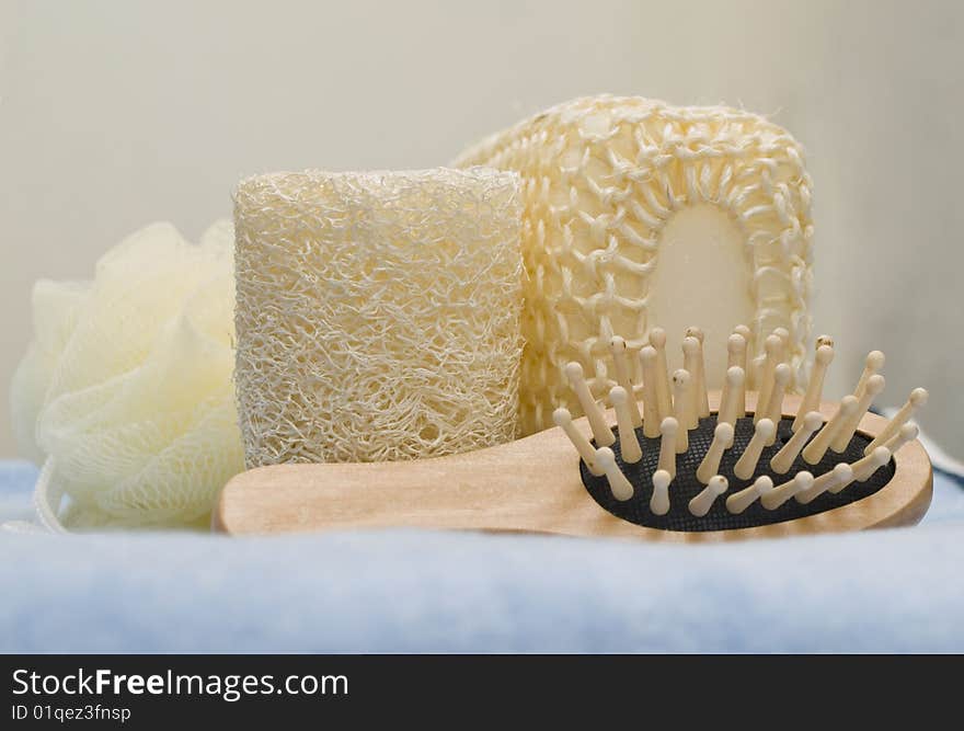 Bath sponges and massage brush for bath on a blue towel. Bath sponges and massage brush for bath on a blue towel