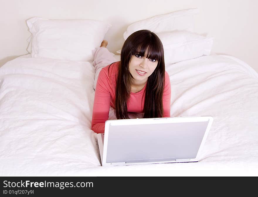 Woman using laptop in bed