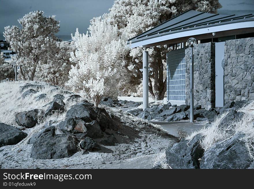 Surreal infrared photo of beach changing rooms