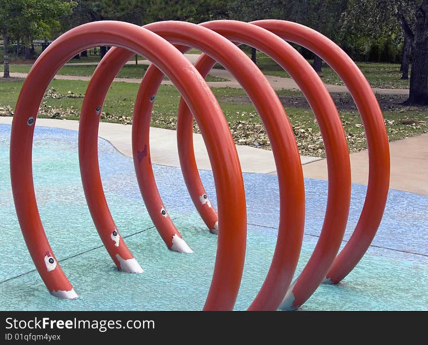 A red circled jungle gym at a playground for kids