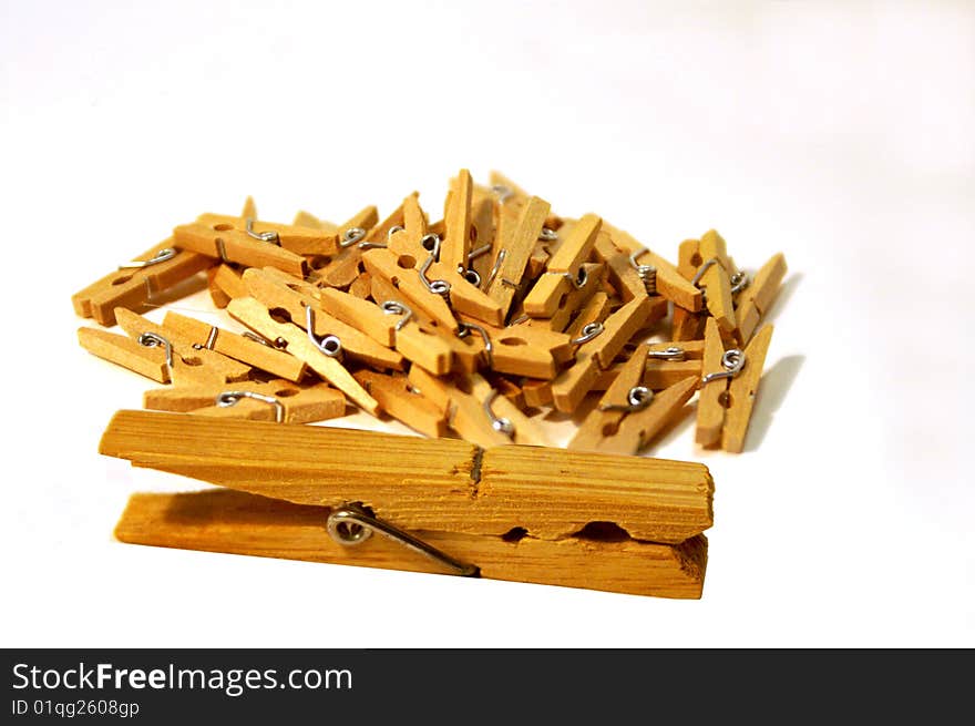 Bunch of little clothes pins with one larger parent or teacher clothes pin