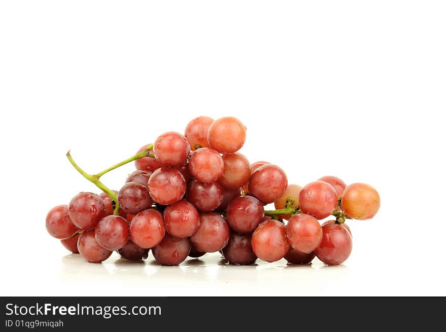 Red seedless grapes bunch isolated over white. Red seedless grapes bunch isolated over white