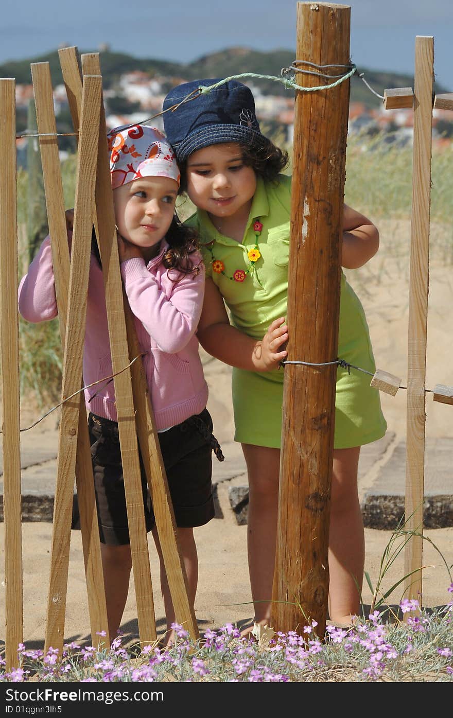 Two little girls playing on the beach