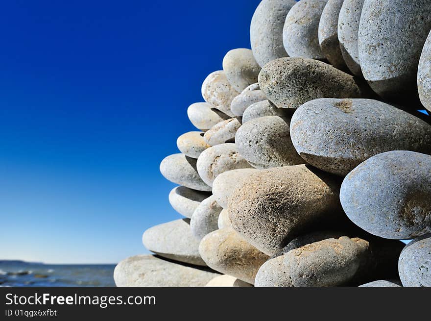 Some quantity cobblestones one on another on sea coast. Some quantity cobblestones one on another on sea coast