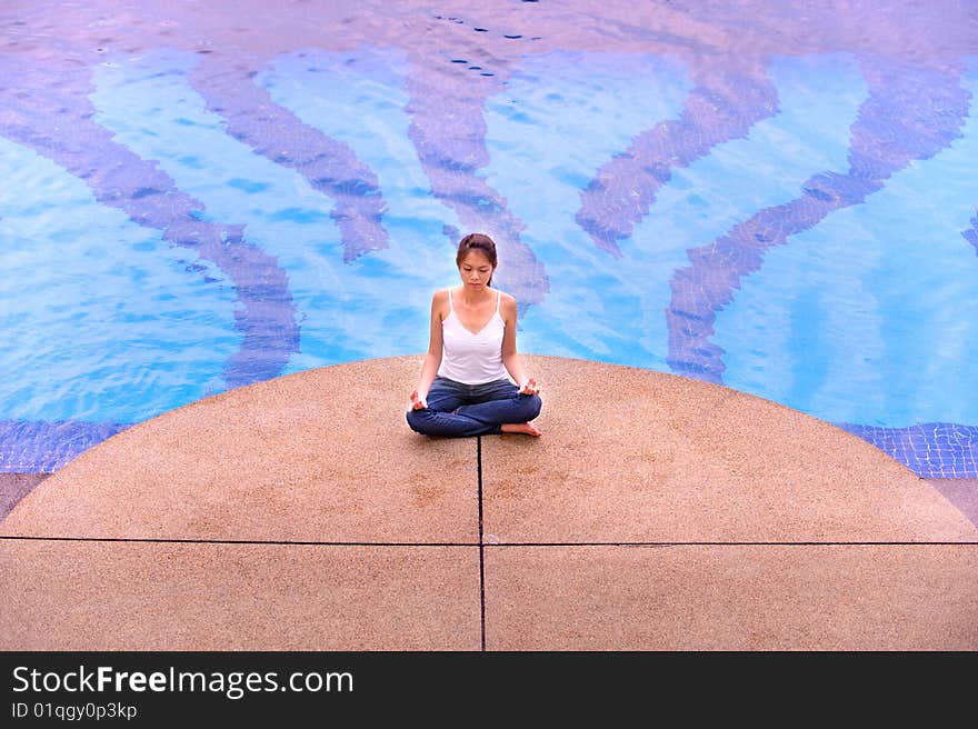 An image of an asian girl meditating. An image of an asian girl meditating