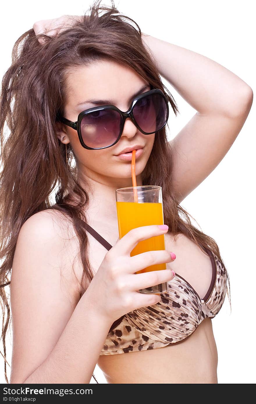 Beautiful women in swimsuit with a glass of juice on a white background isolated