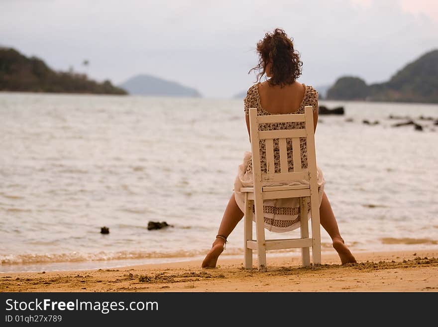 Woman to sit on the chair at sunset. Woman to sit on the chair at sunset.