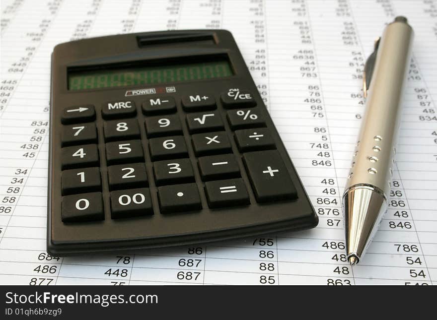 Calculator and pen on a white background. Calculator and pen on a white background