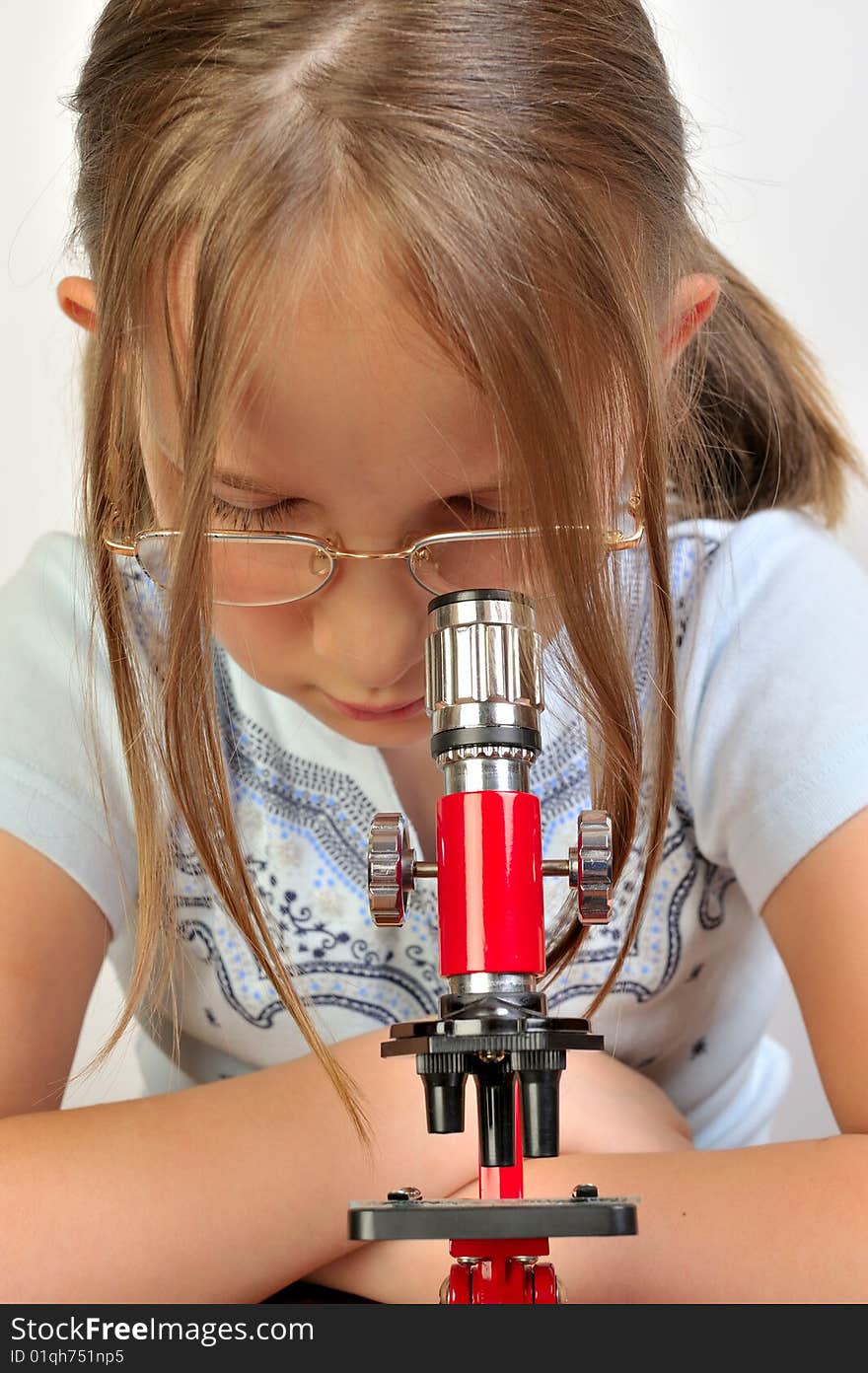 Girl studying something with microscope