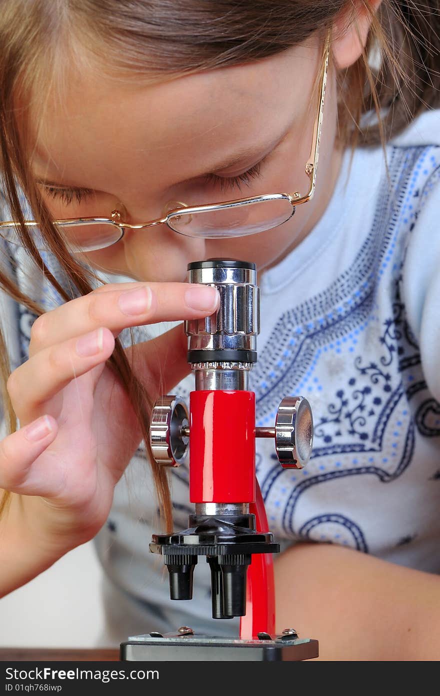 Girl studying something with microscope