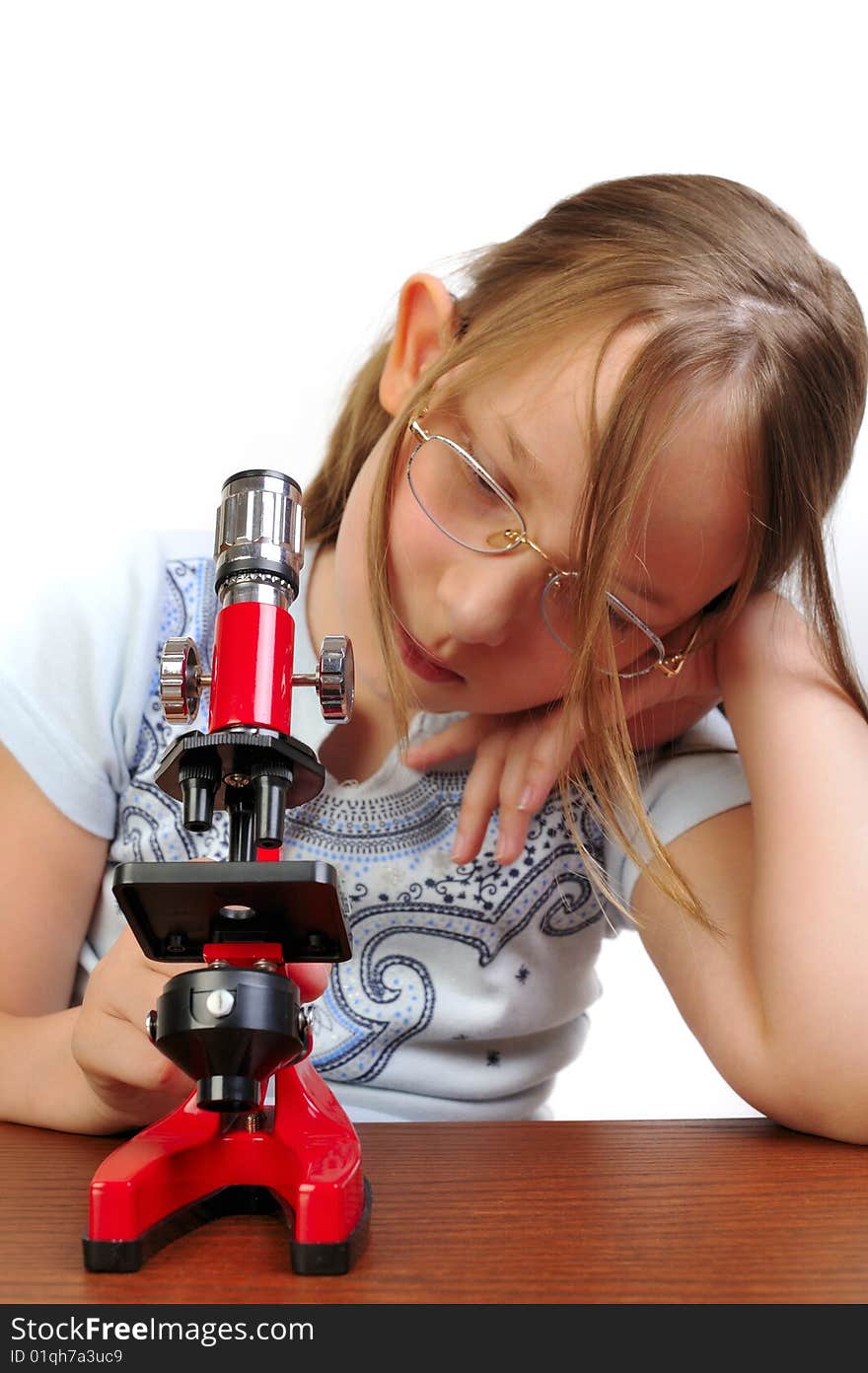 Girl studying something with microscope