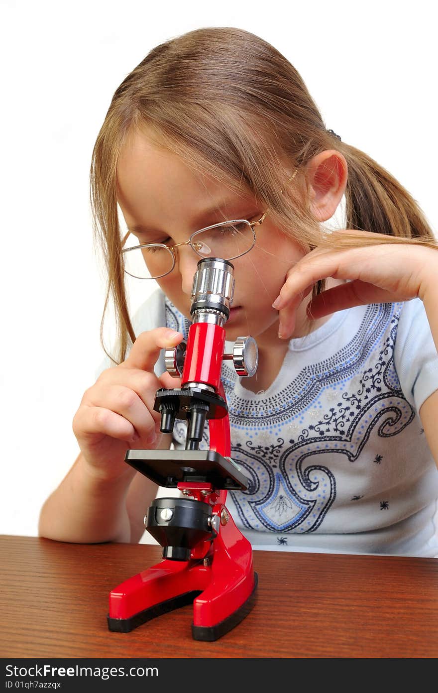 Girl studying something with microscope