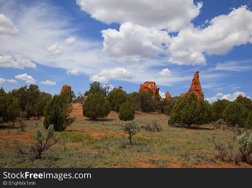 View of the red rock formations in Kodachrome Basin with blue skys and clouds