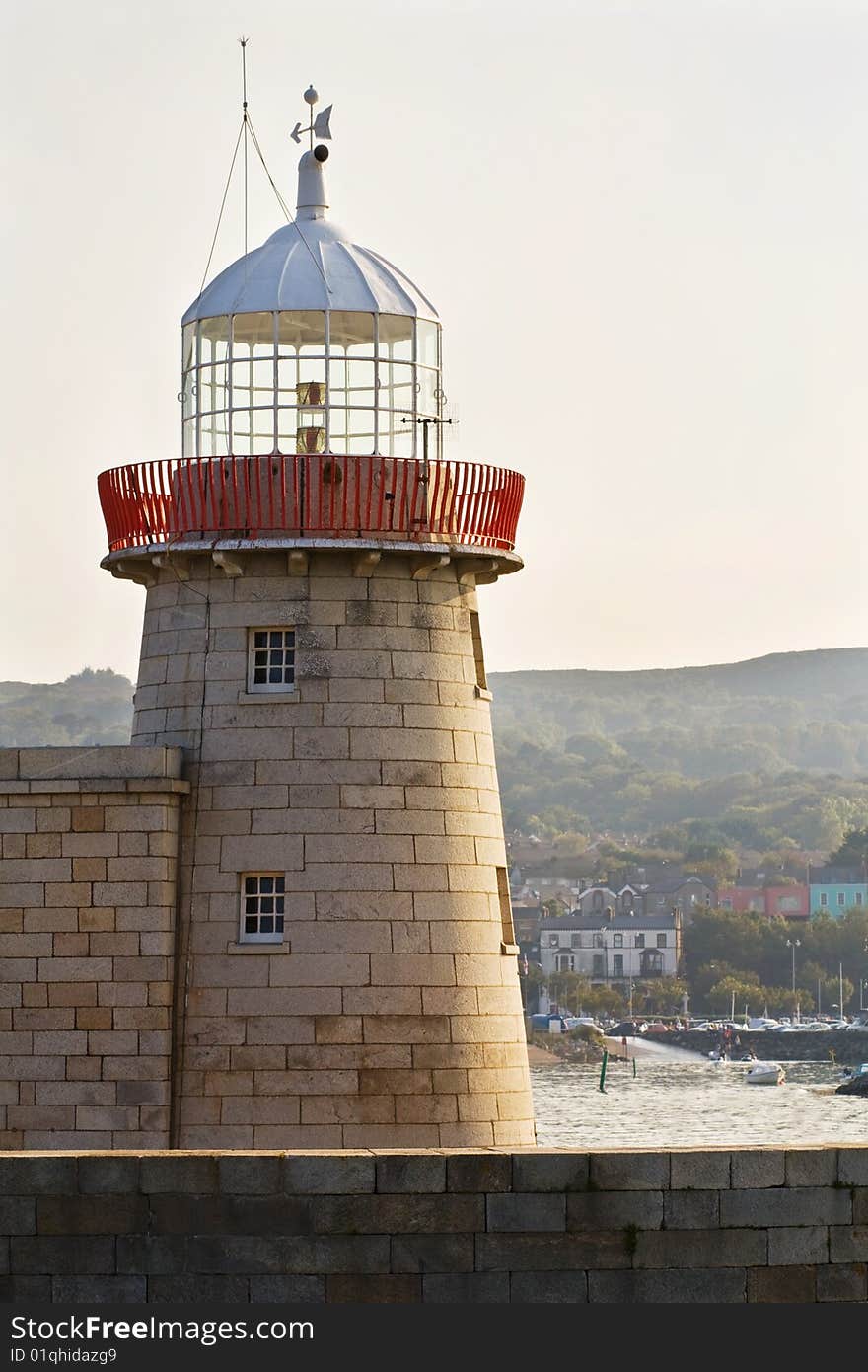 Historic lighthouse on the Howth pier in Dublin, Ireland. Sunset of a beautiful summer day. Historic lighthouse on the Howth pier in Dublin, Ireland. Sunset of a beautiful summer day.