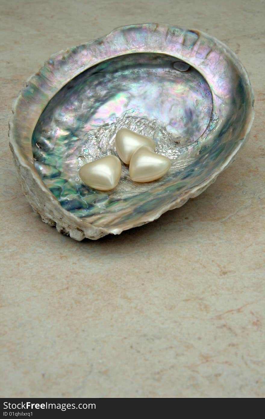 Heart shaped bath pearls on a shell. Heart shaped bath pearls on a shell