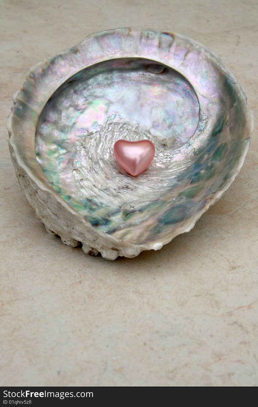 Heart shaped bath pearl on a shell. Heart shaped bath pearl on a shell