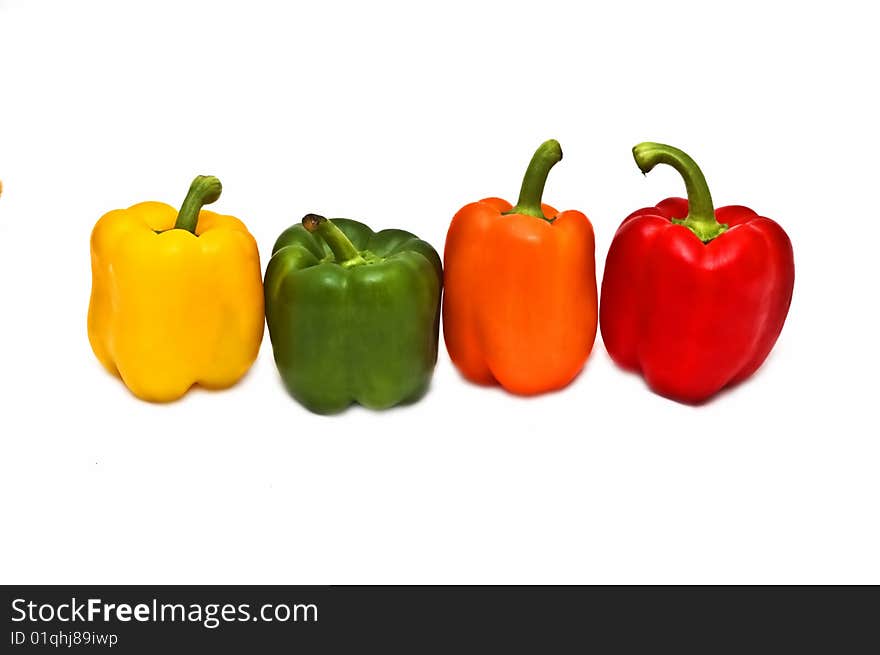 Photo of four colorful peppers