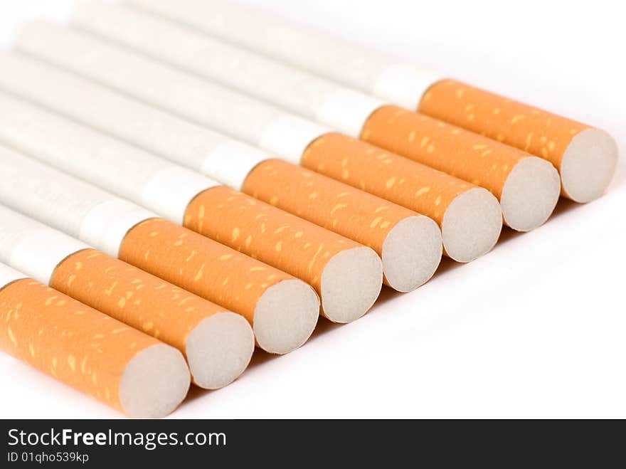 Row of cigarettes on white background