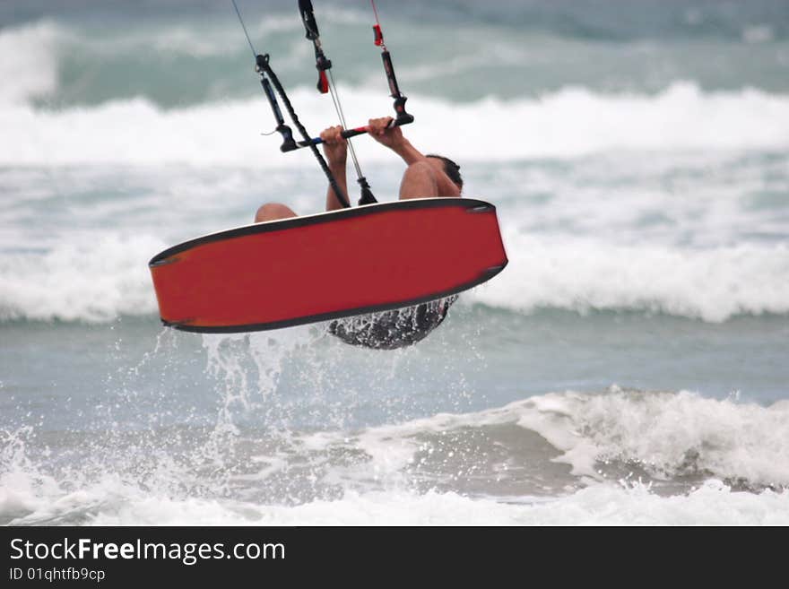 Kitesurfer surfing on the waves