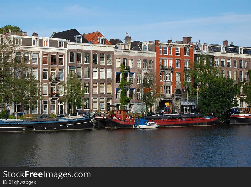 Old Canal Houses in Amsterdam at the water