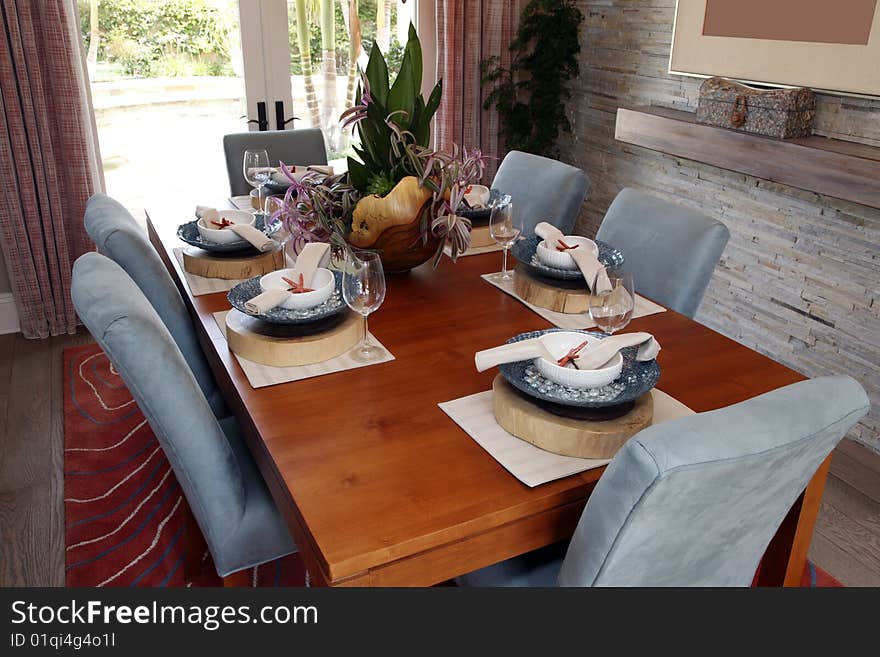 Luxury home dining room table with exquisite tableware and decor.