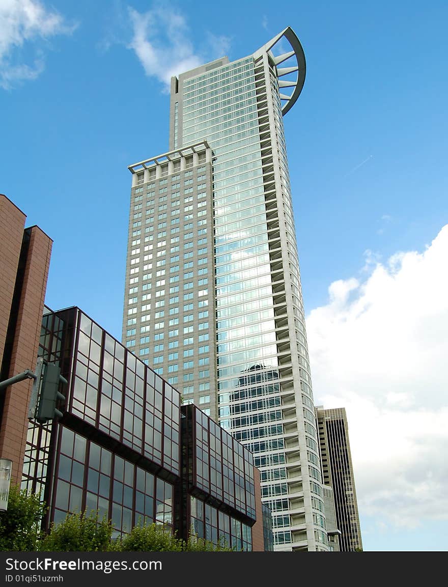 High modern skyscraper on a background of the blue sky. Frankfurt am Main, Germany