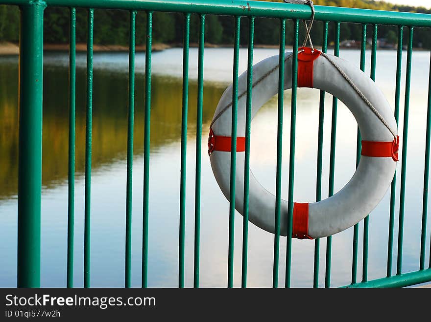 Life buoy on a green metal fence