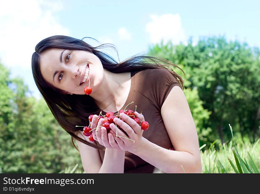 Portrait of the happy girl with cherry