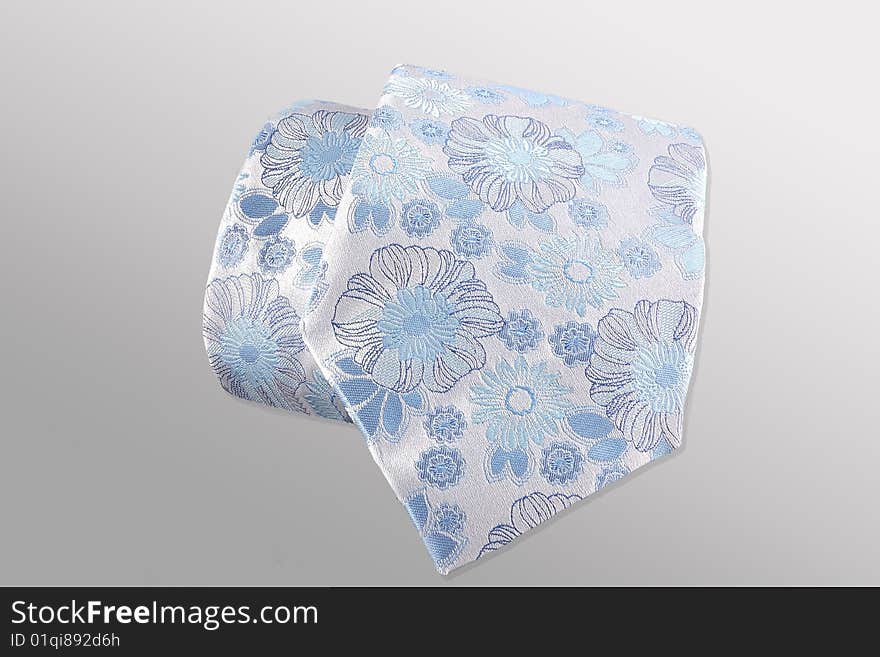 Blue tie on a grey background