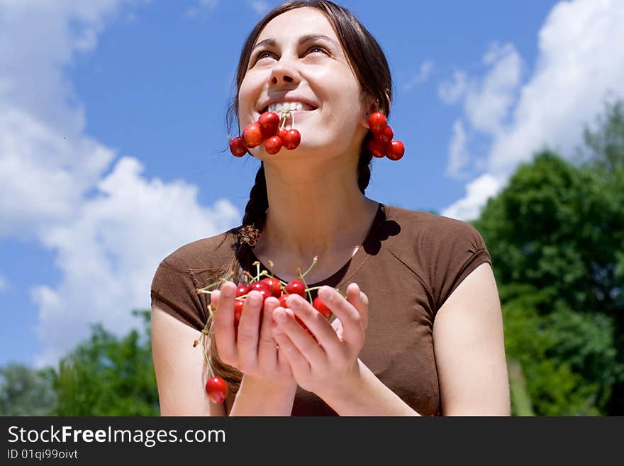 Portrait of the happy girl with cherry