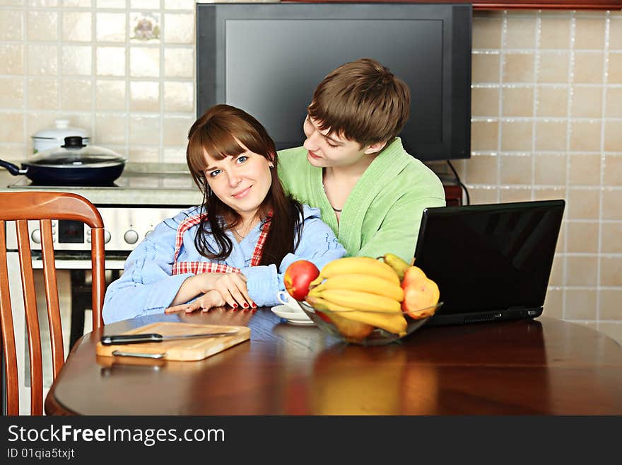 Happy young couple on a kitchen at home. Happy young couple on a kitchen at home.