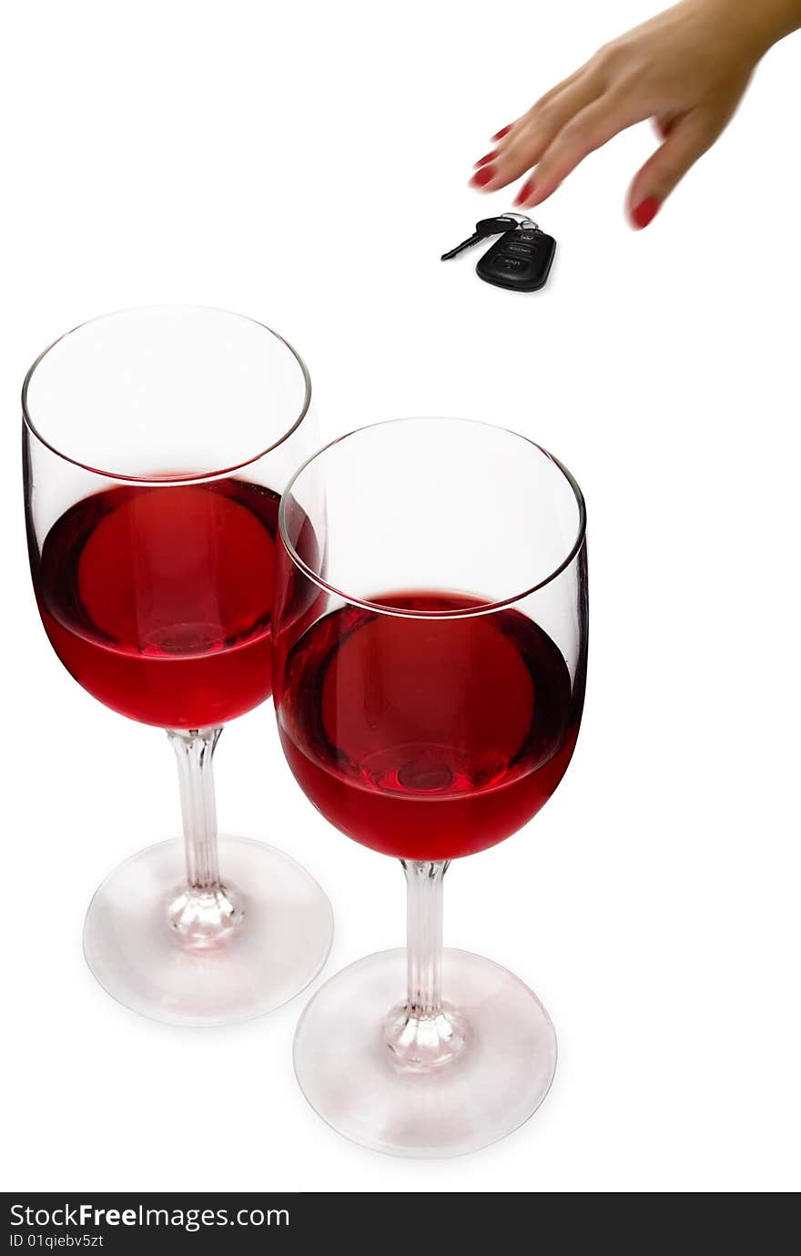 Two glasses of red wine with a woman's hand reaching for car keys. Two glasses of red wine with a woman's hand reaching for car keys