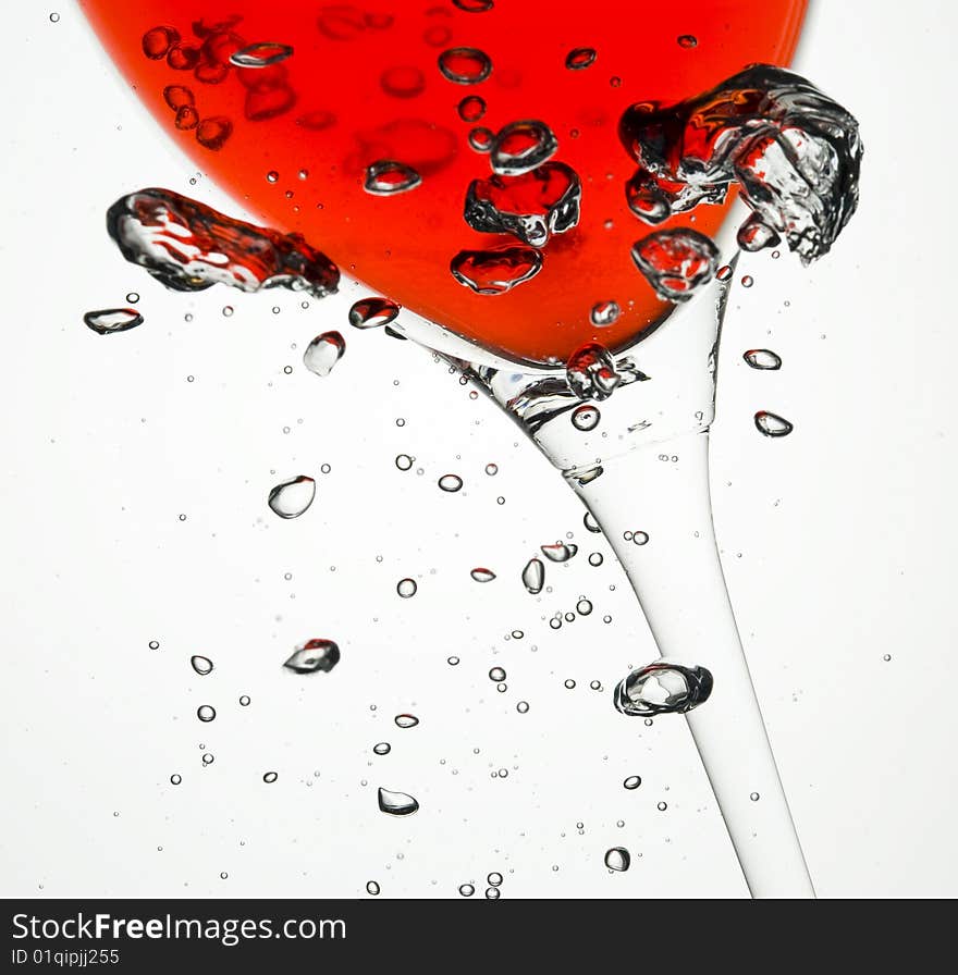 Red wine with Creative water bubbles. Wineglass