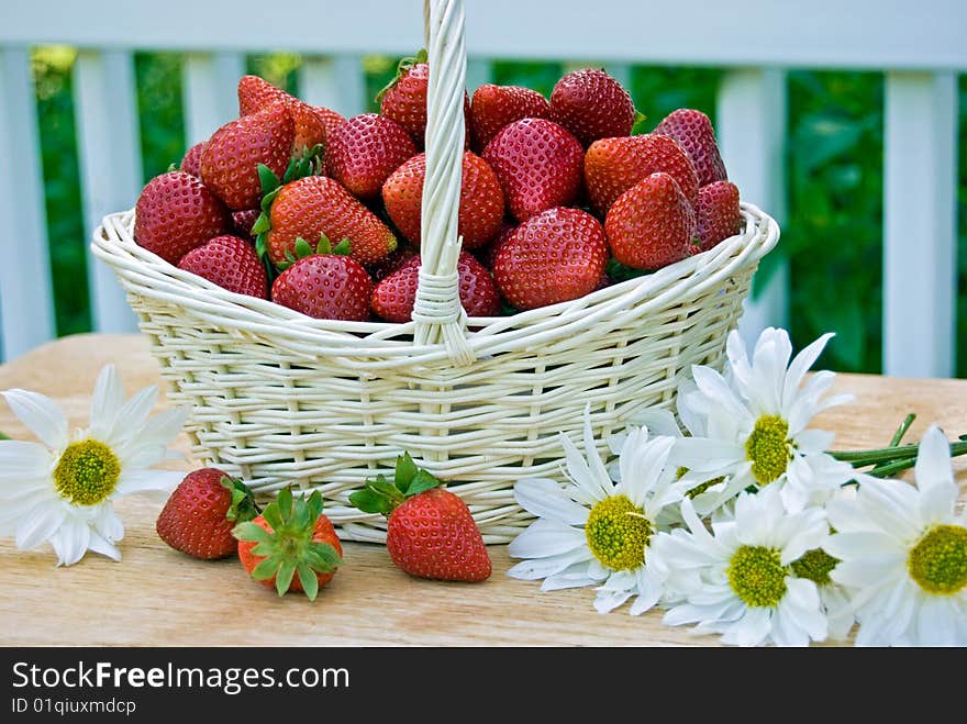 Basket of strawberries with daisies. Basket of strawberries with daisies.