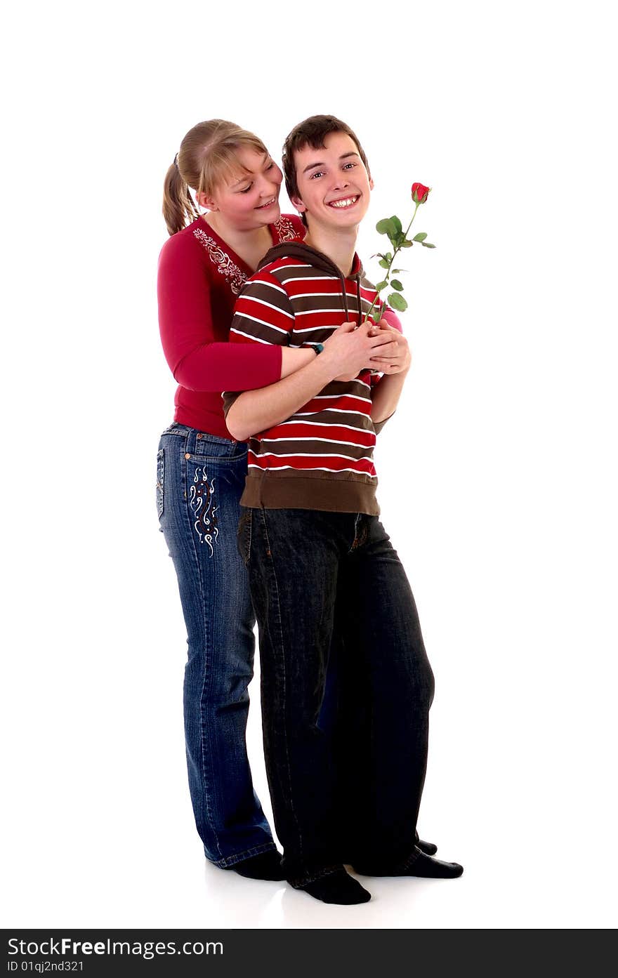 Two casual dressed teenagers , teenage man holding rose flower and woman in love. studio shot. Two casual dressed teenagers , teenage man holding rose flower and woman in love. studio shot.