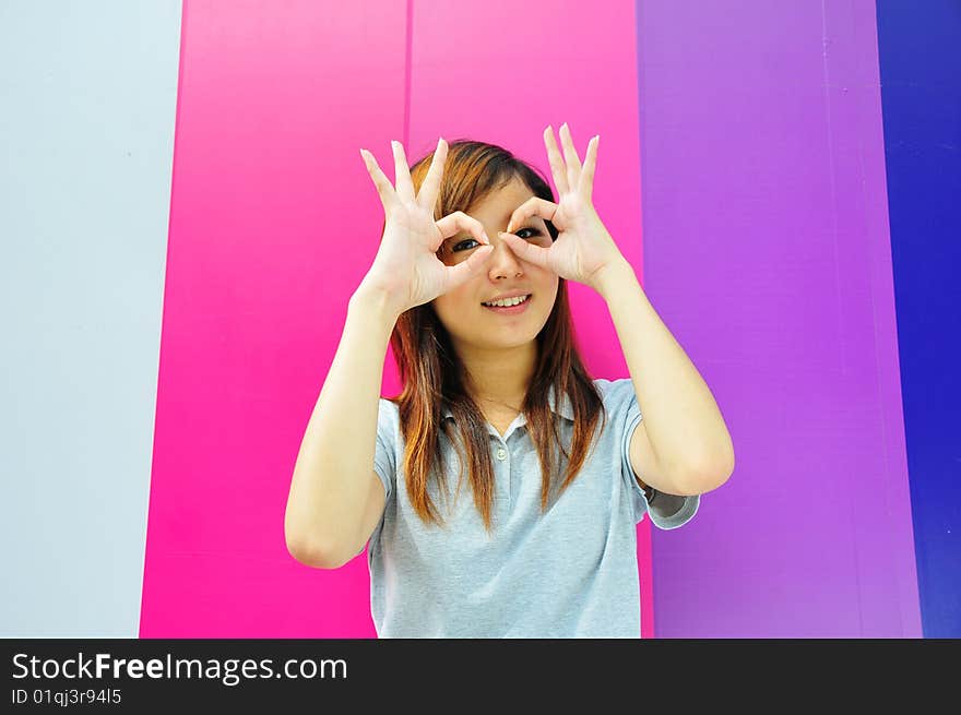 Smiling Beautiful Casual Asian Woman making funny actions. Smiling Beautiful Casual Asian Woman making funny actions.