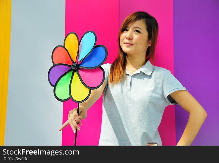 Beautiful Casual Young Woman Holding Colourful Fan. Beautiful Casual Young Woman Holding Colourful Fan.