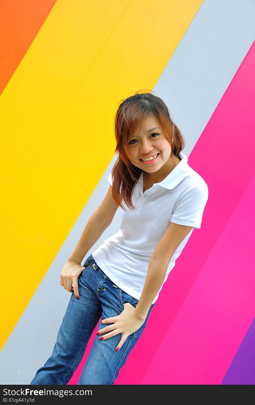 Smiling beautiful young Asian woman with colourful background. Smiling beautiful young Asian woman with colourful background.