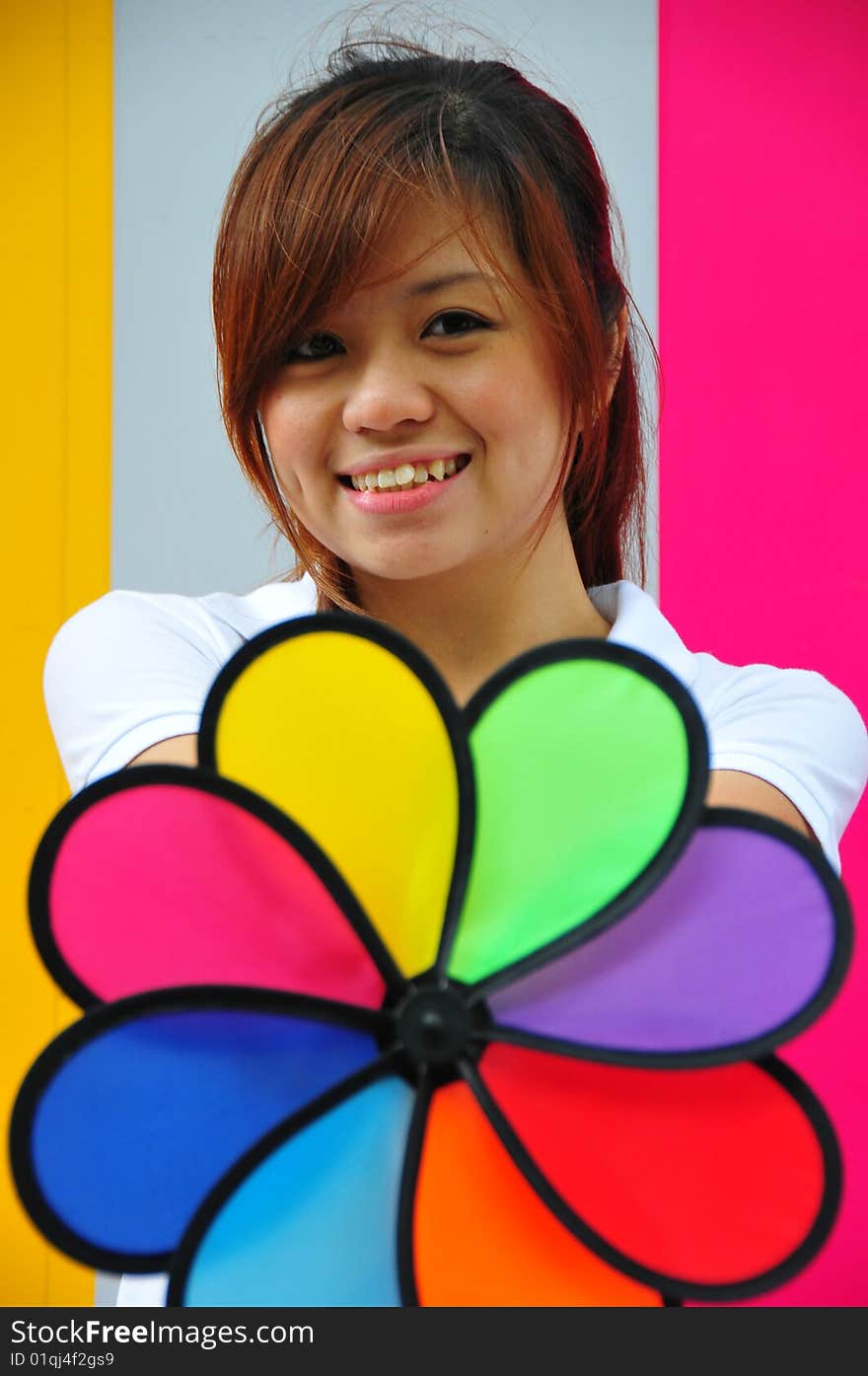 Smiling beautiful young Asian woman with colourful background. Smiling beautiful young Asian woman with colourful background.